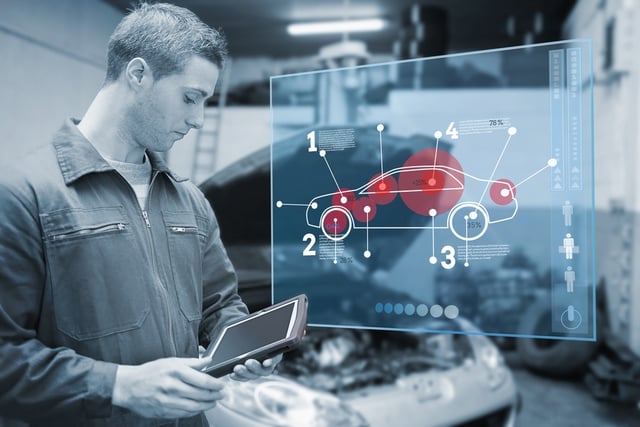 Mechanic using tablet and futuristic interface with diagram  in black and white.jpeg